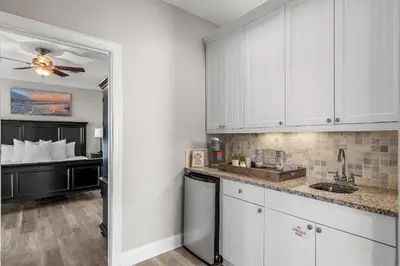 a kitchen with white cabinets and a sink at Emerald Escape in Santa Rosa Beach