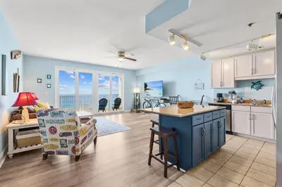 a kitchen and living room with a view of the ocean at Spacious 1-Bedroom! Ocean Views & 5 Pools Resort! by Dolce Vita Getaways PCB in Panama City Beach