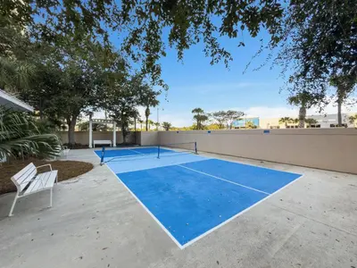 a tennis court in the middle of a driveway at Spacious 1-Bedroom! Ocean Views & 5 Pools Resort! by Dolce Vita Getaways PCB in Panama City Beach