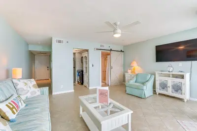 a living room with a couch and a table at Gulf-View Balcony Beachfront Condo in PCB! in Panama City Beach