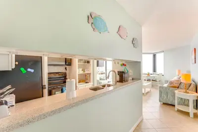 a kitchen and living room with a counter top at Gulf-View Balcony Beachfront Condo in PCB! in Panama City Beach