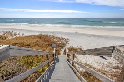 a stairway to the beach with the ocean in the background at A Winterpast by the Sea - Gulf Front with Private Pool in Santa Rosa Beach