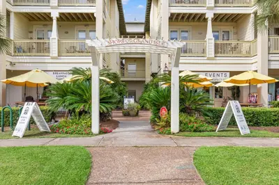 a hotel with a sign in front of a building at A Winterpast by the Sea - Gulf Front with Private Pool in Santa Rosa Beach