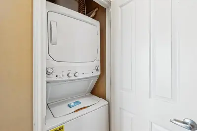 a white refrigerator with a microwave inside of it at Shores of Panama 2302 condo in Panama City Beach