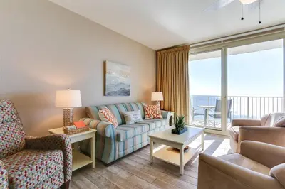 a living room with a couch and a chair at Shores of Panama 1602 condo in Panama City Beach