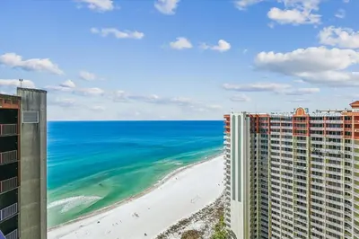 a view of the beach from the balcony of a building at Shores of Panama 2325 condo in Panama City Beach