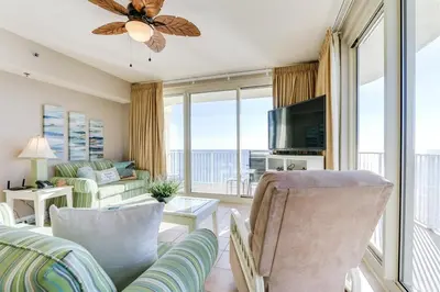 a living room with a couch and chairs and a television at Shores of Panama 1601 condo in Panama City Beach