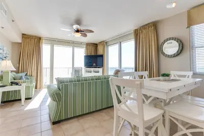 a living room with a couch and a table at Shores of Panama 1601 condo in Panama City Beach
