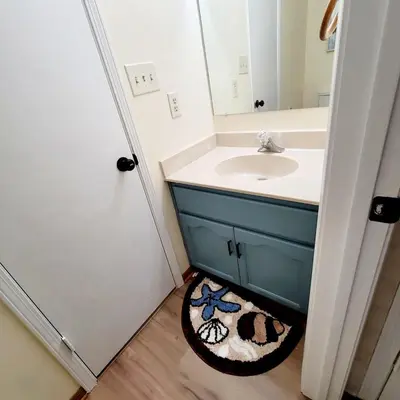 a bathroom with a sink and a mirror at Spacious 3BR Family Beach Home 5 Mins to Panama City Beach & Sleeps 9 Hot tub in Panama City Beach
