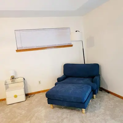 a blue chair and a ottoman in a room at Spacious 3BR Family Beach Home 5 Mins to Panama City Beach & Sleeps 9 Hot tub in Panama City Beach