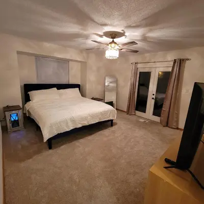 a bedroom with a bed and a ceiling fan at Spacious 3BR Family Beach Home 5 Mins to Panama City Beach & Sleeps 9 Hot tub in Panama City Beach
