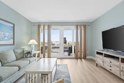 a living room with a couch and a flat screen tv at Laketown Wharf #0226 in Panama City Beach