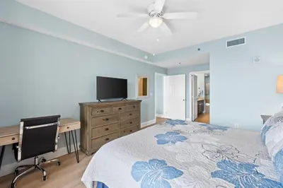 a bedroom with a bed and a desk and a tv at Laketown Wharf #0226 in Panama City Beach