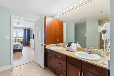 a bathroom with two sinks and a bedroom at Laketown Wharf #0226 in Panama City Beach