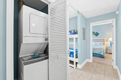 a white refrigerator in a room with a bedroom at Laketown Wharf #0226 in Panama City Beach
