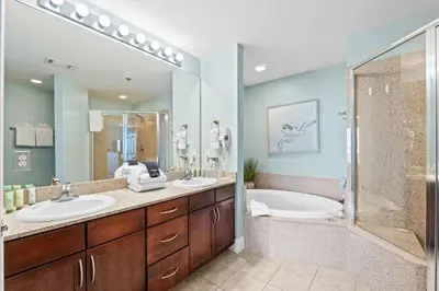 a bathroom with two sinks and a tub and a shower at Laketown Wharf #0226 in Panama City Beach