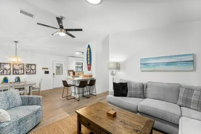 a living room with a couch and a table at Aqua Believe It in Panama City Beach