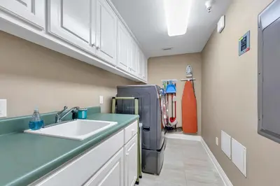 a kitchen with a sink and a refrigerator at Hidden Dunes 503 in Panama City Beach