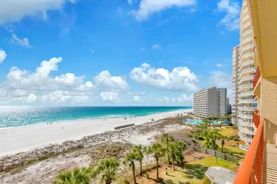 a view of the beach from the balcony of a building at Hidden Dunes 503 in Panama City Beach