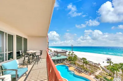 a balcony with a view of the beach and the ocean at Hidden Dunes 503 in Panama City Beach