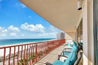 a balcony with chairs and a view of the beach at Hidden Dunes 503 in Panama City Beach
