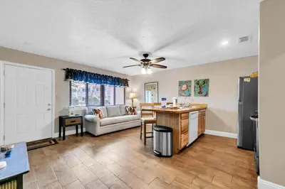 a kitchen and living room with a ceiling fan at Hidden Beach Villas 122 - A Sunset Paradise in Santa Rosa Beach