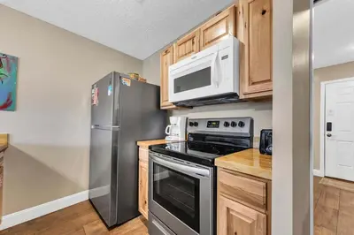 a kitchen with a stainless steel refrigerator and microwave at Hidden Beach Villas 122 - A Sunset Paradise in Santa Rosa Beach