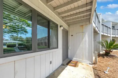a house with windows on the side of it at Hidden Beach Villas 122 - A Sunset Paradise in Santa Rosa Beach