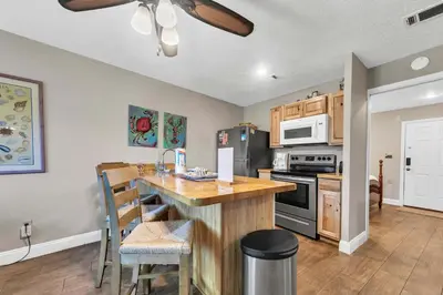 a kitchen with a counter top and a stove top oven at Hidden Beach Villas 122 - A Sunset Paradise in Santa Rosa Beach