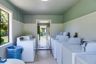 a room filled with white washers and dryers at Hidden Beach Villas 122 - A Sunset Paradise in Santa Rosa Beach