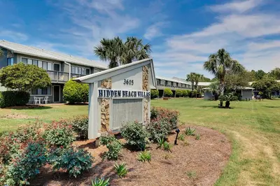 a sign in front of a building at Hidden Beach Villas 122 - A Sunset Paradise in Santa Rosa Beach
