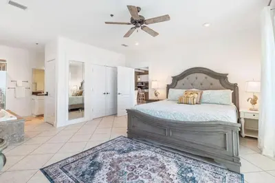 a bedroom with a bed and a ceiling fan at Beachfront, 4 Bed , White Sands Haven, Penthouse ,Pool in Panama City Beach