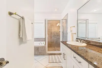 a white bathroom with a sink and a shower at Beachfront, 4 Bed , White Sands Haven, Penthouse ,Pool in Panama City Beach
