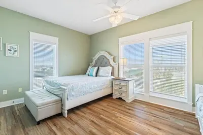 a bedroom with a bed and a ceiling fan at Beachfront, 4 Bed , White Sands Haven, Penthouse ,Pool in Panama City Beach