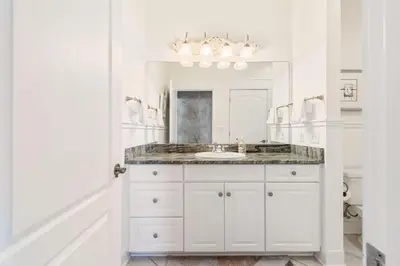 a white bathroom with a sink and a mirror at Beachfront, 4 Bed , White Sands Haven, Penthouse ,Pool in Panama City Beach