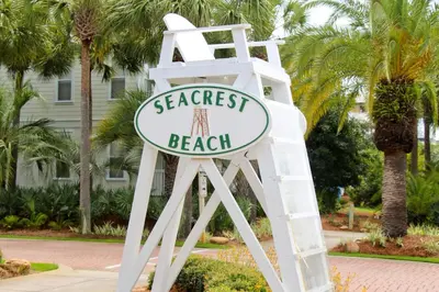 a sign for the beach on a white chair at Inn at Seacrest 309- Somewhere in the Sun in Inlet Beach