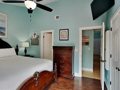 a bedroom with a bed and a ceiling fan at Sunswept Condominium #210 in Panama City Beach