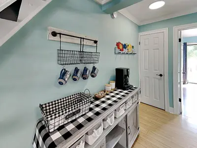 a kitchen with a counter with shoes on the wall at Sunswept Condominium #210 in Panama City Beach