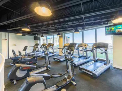 a gym with rows of cardio equipment in a building at Laketown Wharf #913 in Panama City Beach