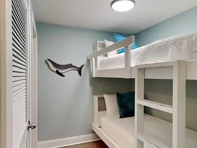 a bunk bed room with a white bunk bed in a bedroom at Laketown Wharf #913 in Panama City Beach