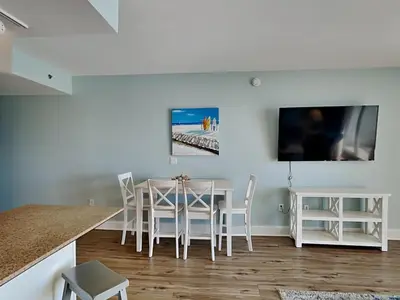 a dining room with a table and a tv at Laketown Wharf #913 in Panama City Beach