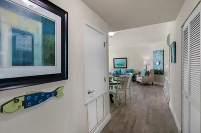 a hallway with a living room and a dining room at Aqua 0411 in Panama City Beach