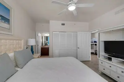 a bedroom with a bed and a ceiling fan at Aqua 0411 in Panama City Beach