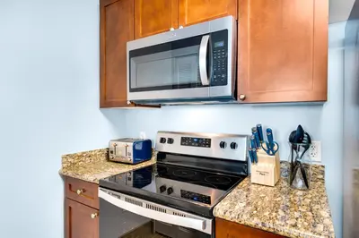 a kitchen with a stove and a microwave at Aqua 1904 in Panama City Beach