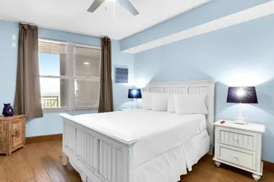 a bedroom with a white bed and a window at Aqua 1904 in Panama City Beach