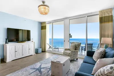 a living room with a view of the ocean at Aqua 1904 in Panama City Beach