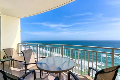 a balcony with a table and chairs and the ocean at Aqua 1904 in Panama City Beach