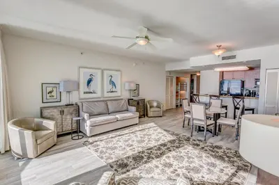 a living room with a couch and chairs and a table at Aqua 1905 in Panama City Beach