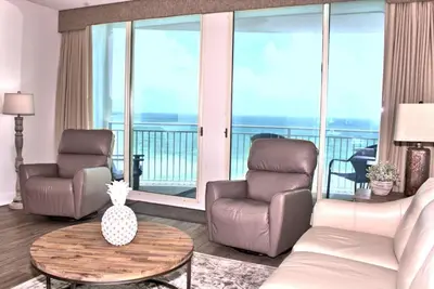 a living room with two chairs and a table at Aqua 0504 in Panama City Beach