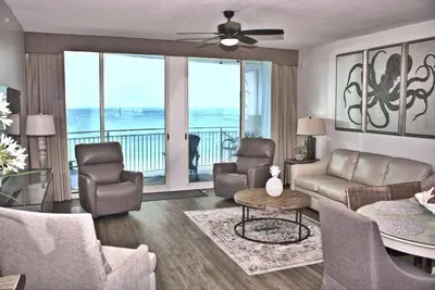 a living room with a couch and chairs and a table at Aqua 0504 in Panama City Beach